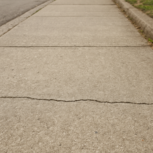 Concrete sidewalk with a straight crack across the surface