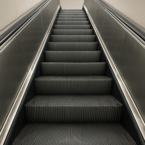 Metal escalator steps showing standard width and ridged surface